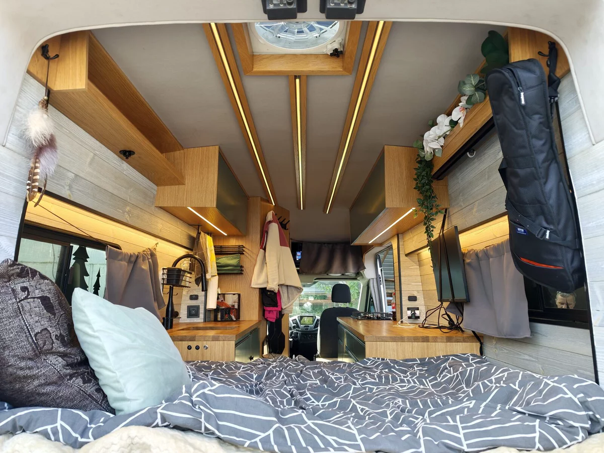 Modern van interior: wood, LED lighting, neat cabinet fronts