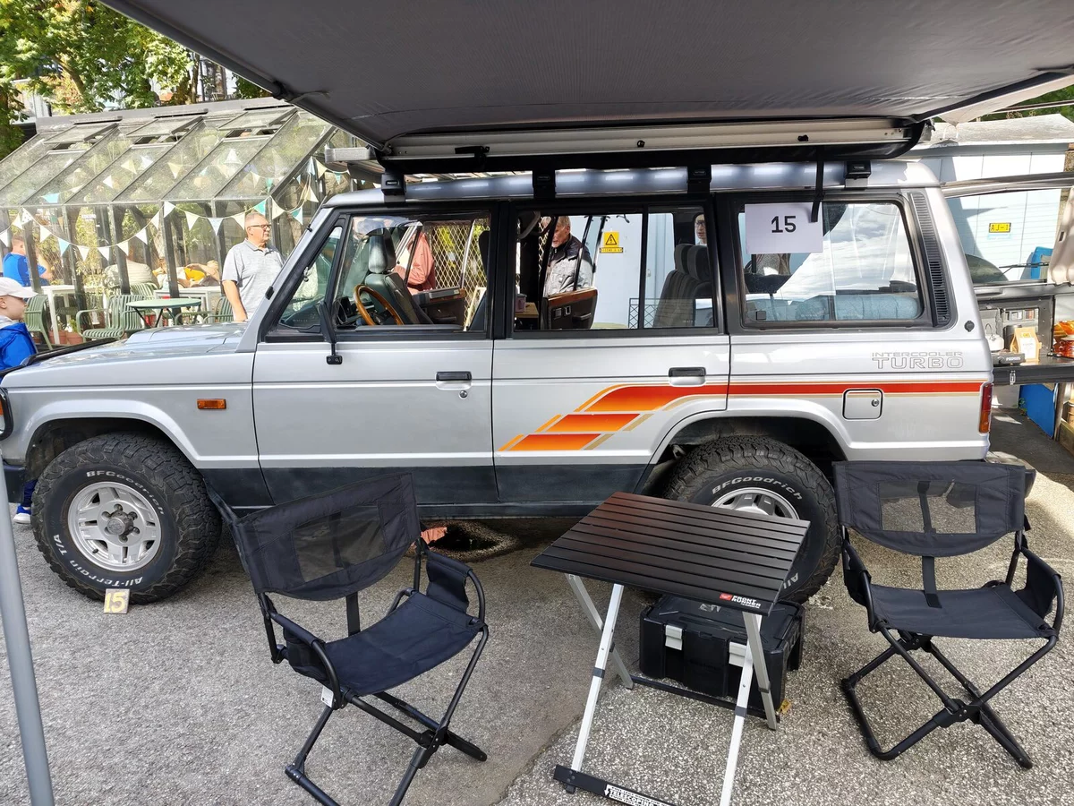 Mitsubishi Pajero with an awning and camping furniture