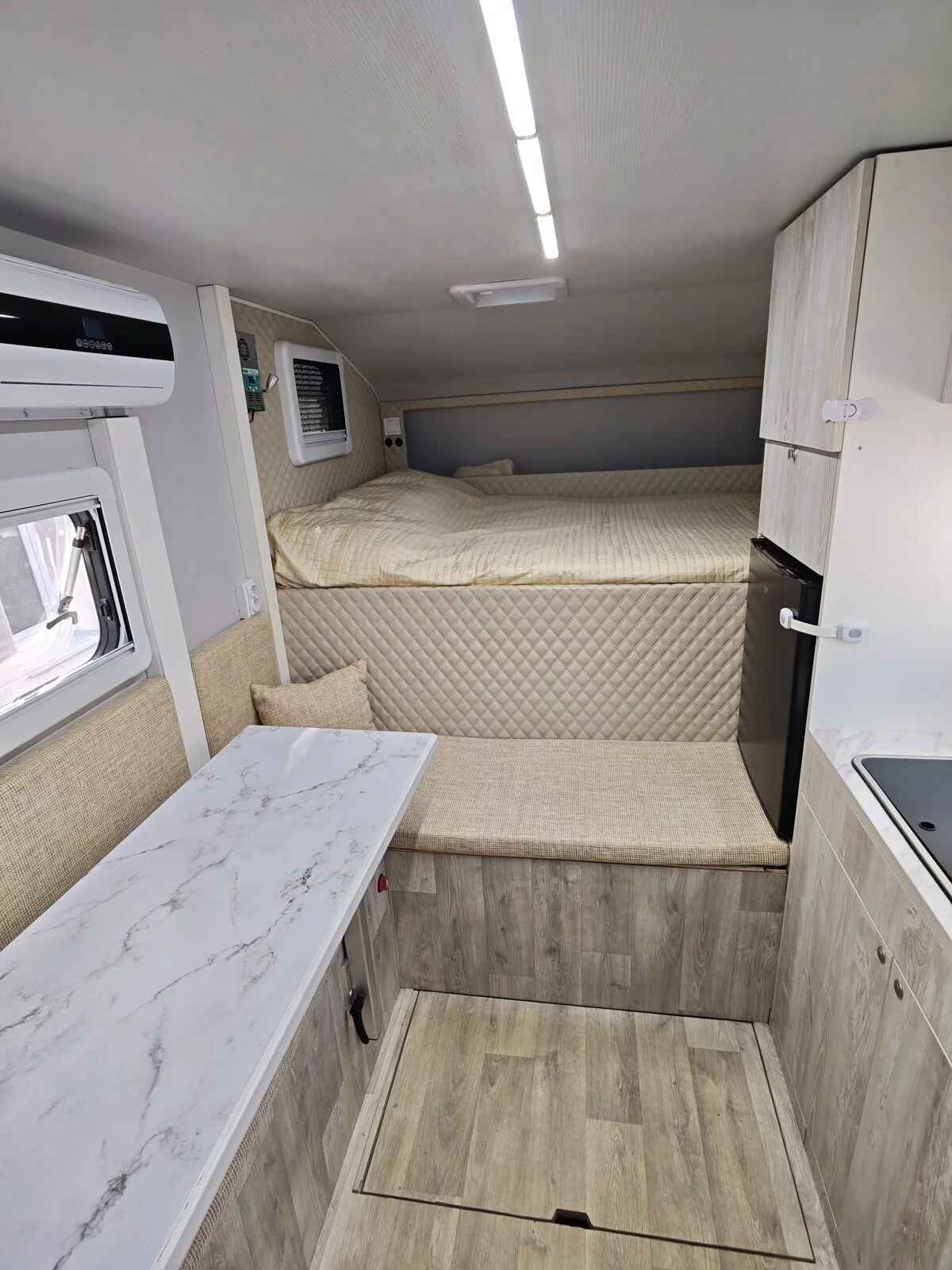 Interior of the camper body: sleeping area, air conditioning