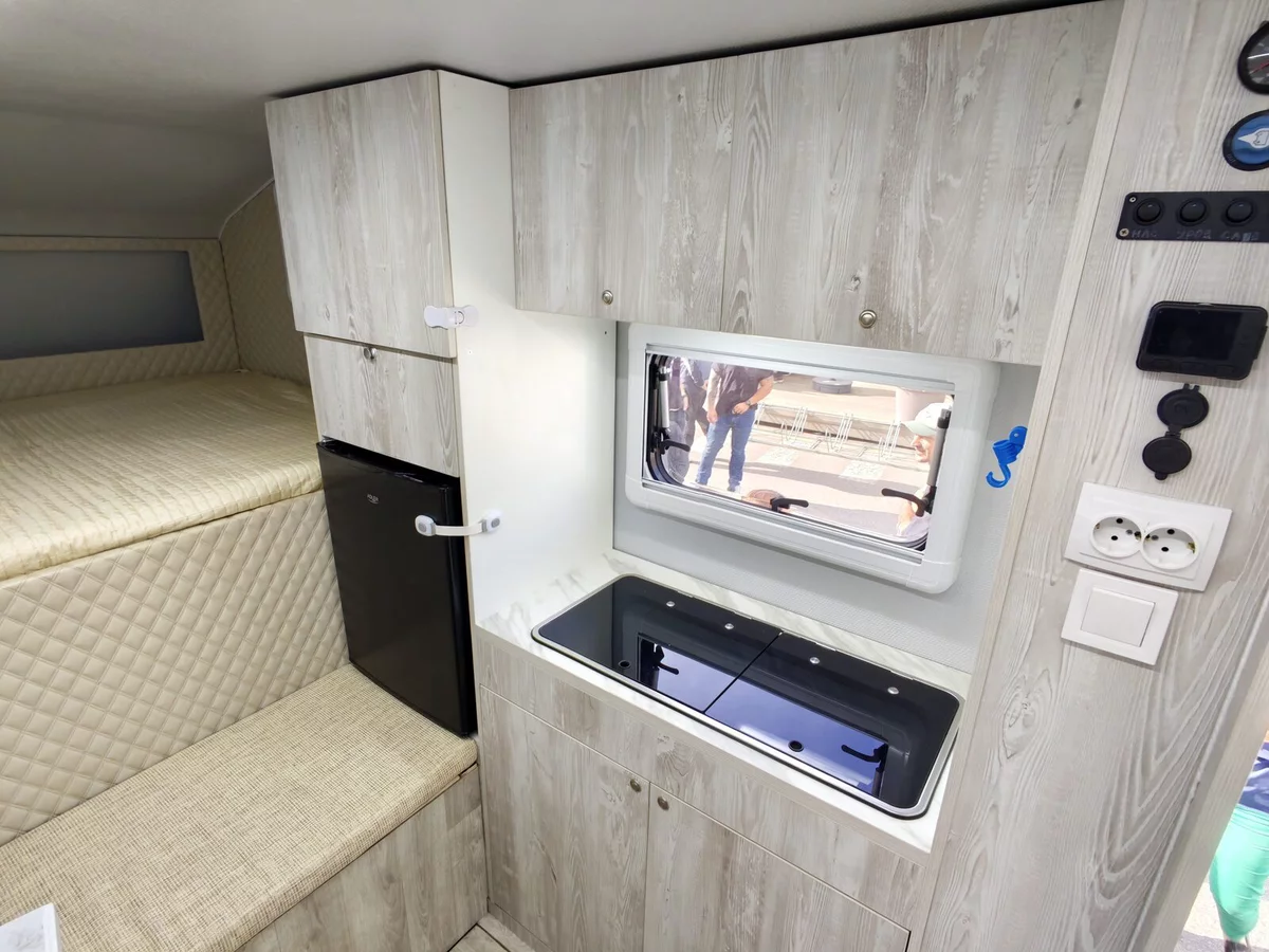 Kitchen, fridge and electrical panel in the camper body