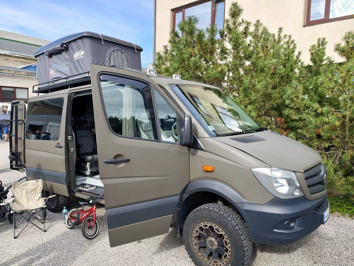 Olive Mercedes Sprinter 4x4 with a roof tent