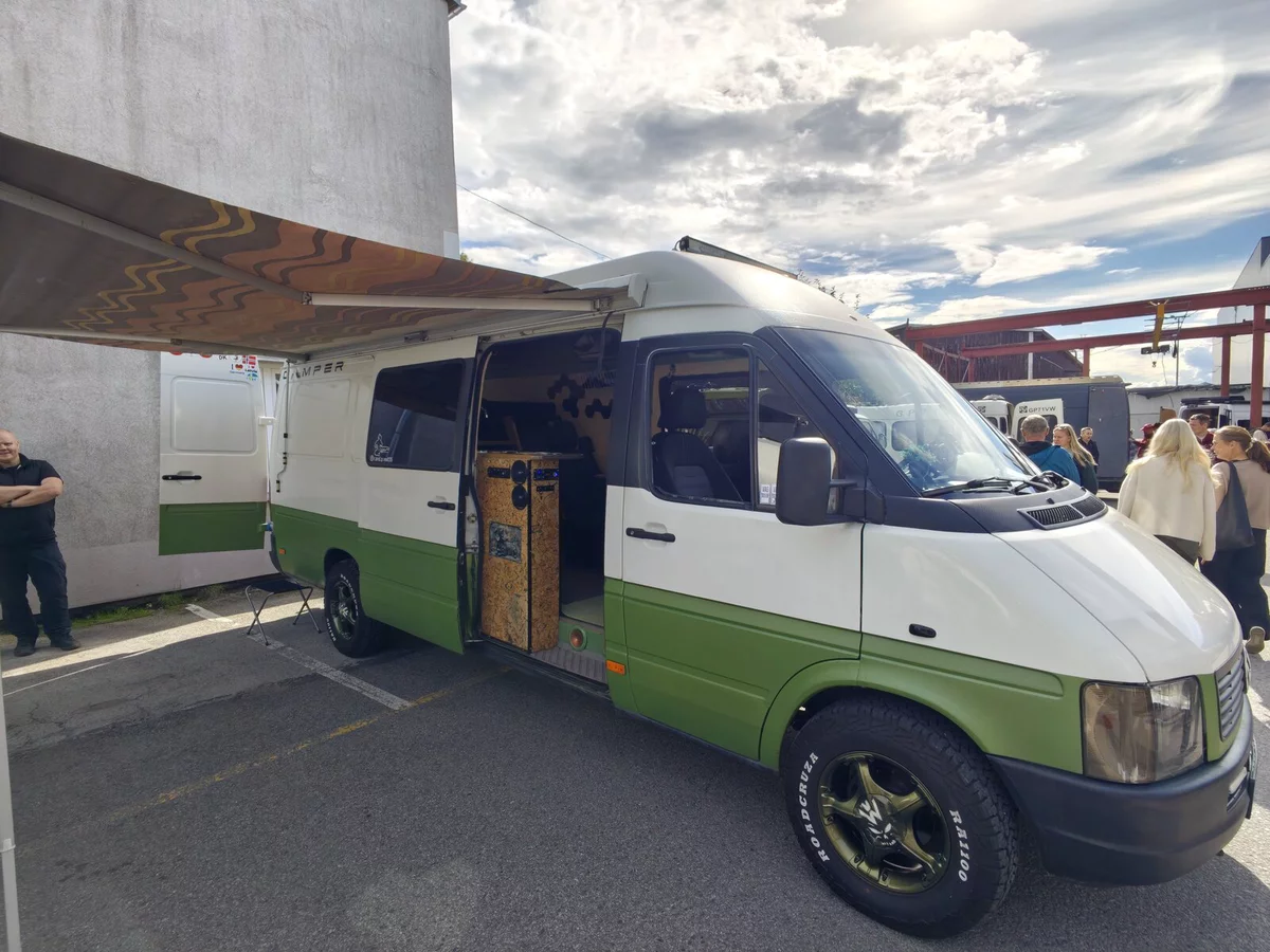 White and green VW LT with an awning and the side door open