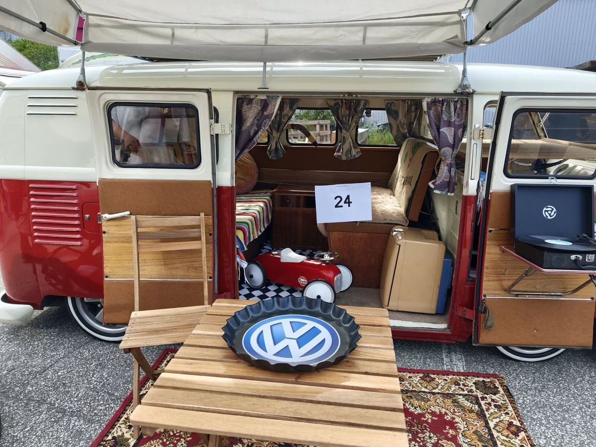 Interior of the red and white VW T1 #24: curtains, record player, pedal car