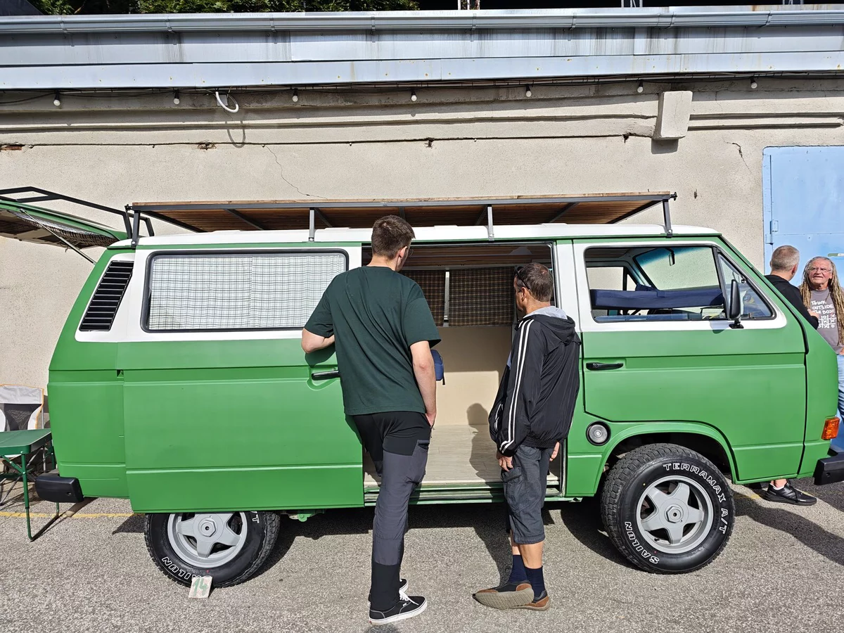 Green VW T3 with an awning