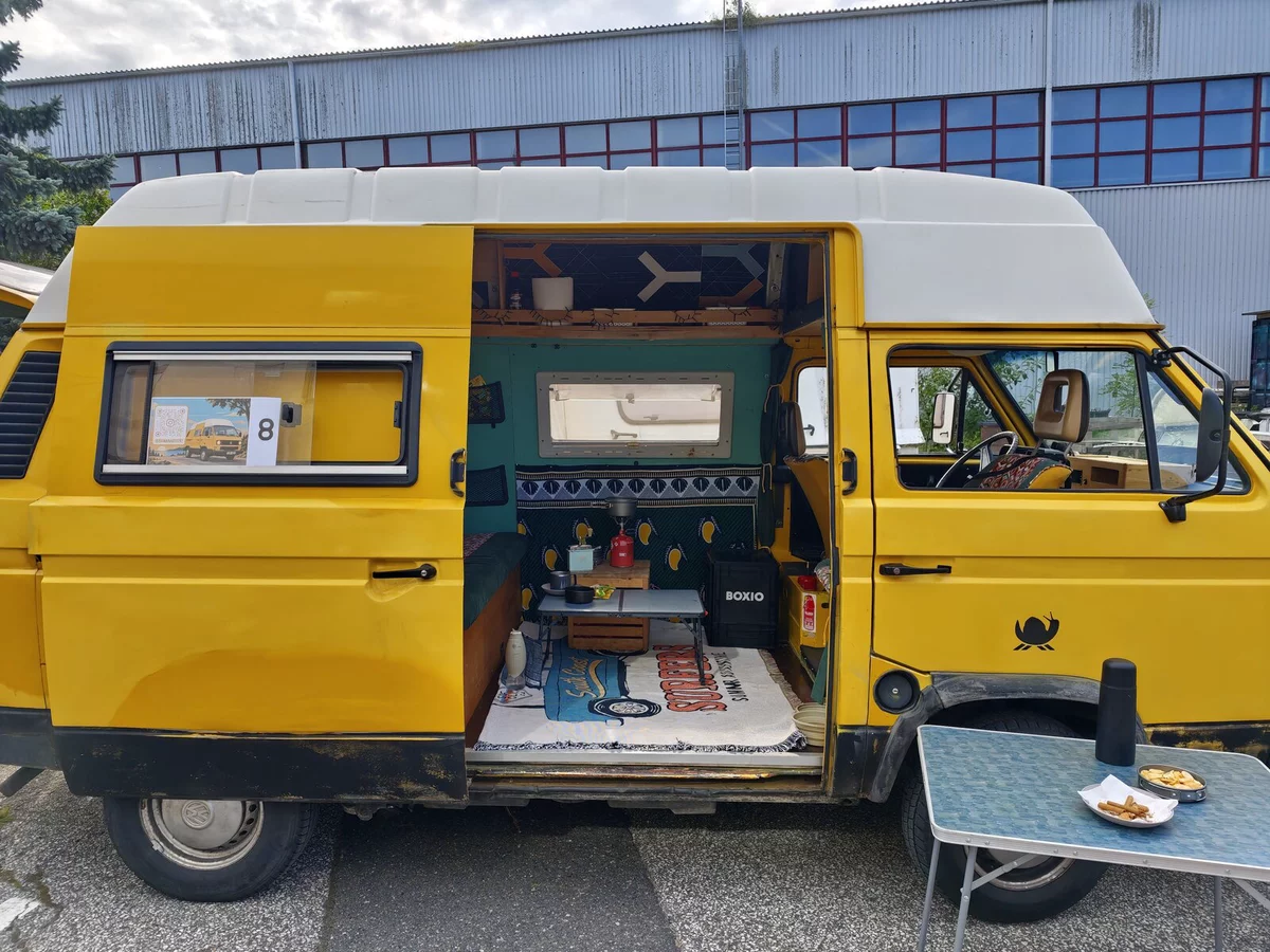 Yellow VW LT #8 with the door open: turquoise kitchen and a carpet